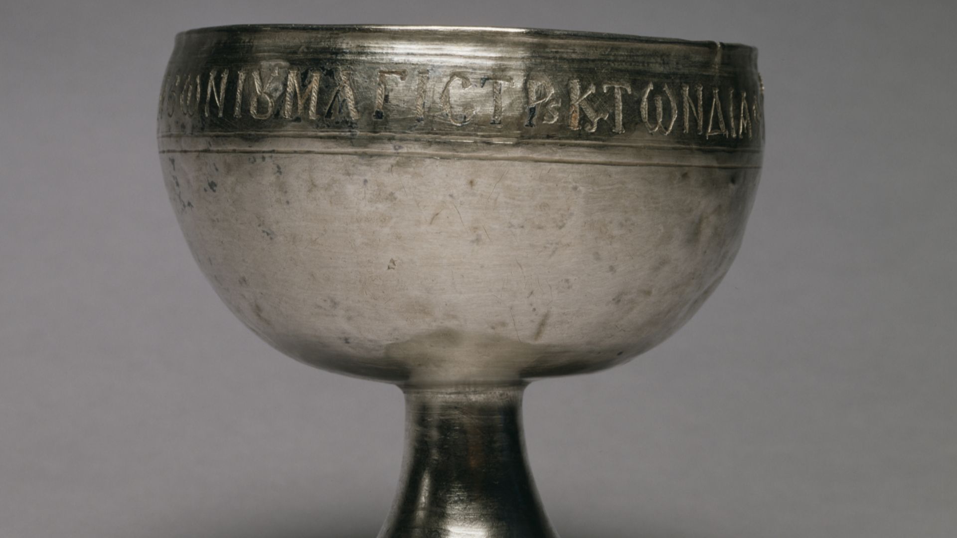 State officials in the early Byzantine Empire often inspected newly made silver objects and stamped them to attest to the purity of the metal. Four such stamps on the bottom of this cup for Communion wine contain, together with the inspectors' names, the monograms of Emperor Justinian (ruled 527-65) and of his minister Peter (served 547-50). The donor of the chalice was a state official whose name is recorded in the text along the rim: