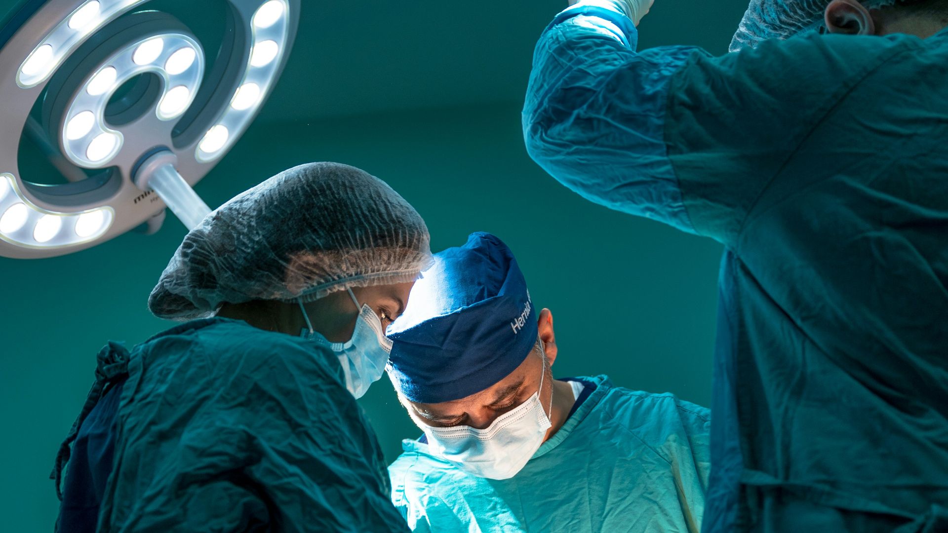 a group of doctors performing surgery on a patient