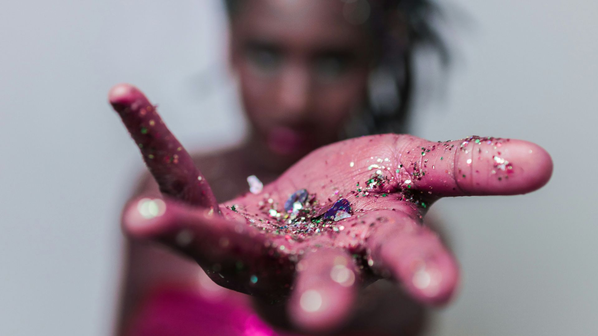 Woman's hand covered in glitter