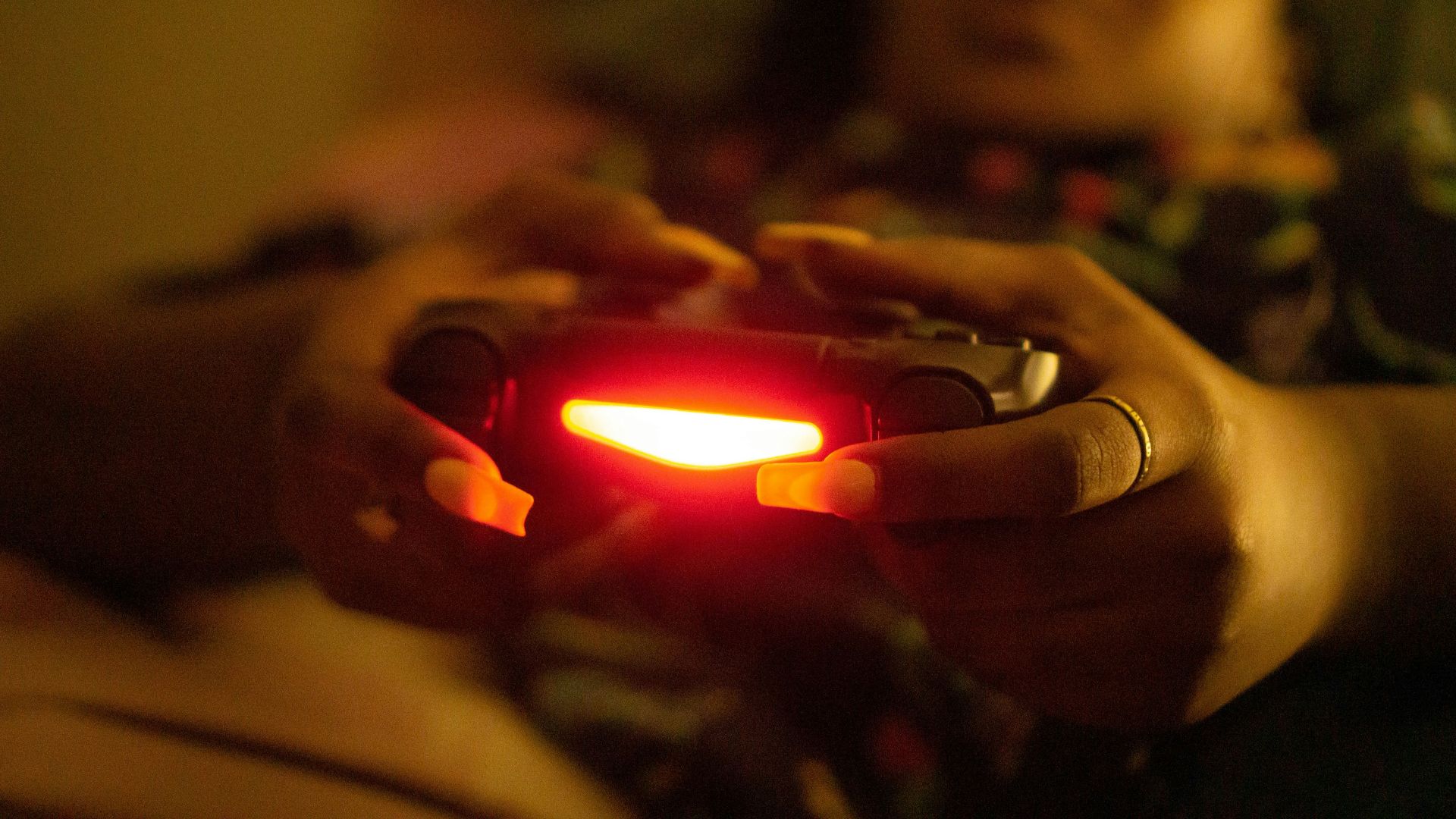 a close up of a person holding a game controller