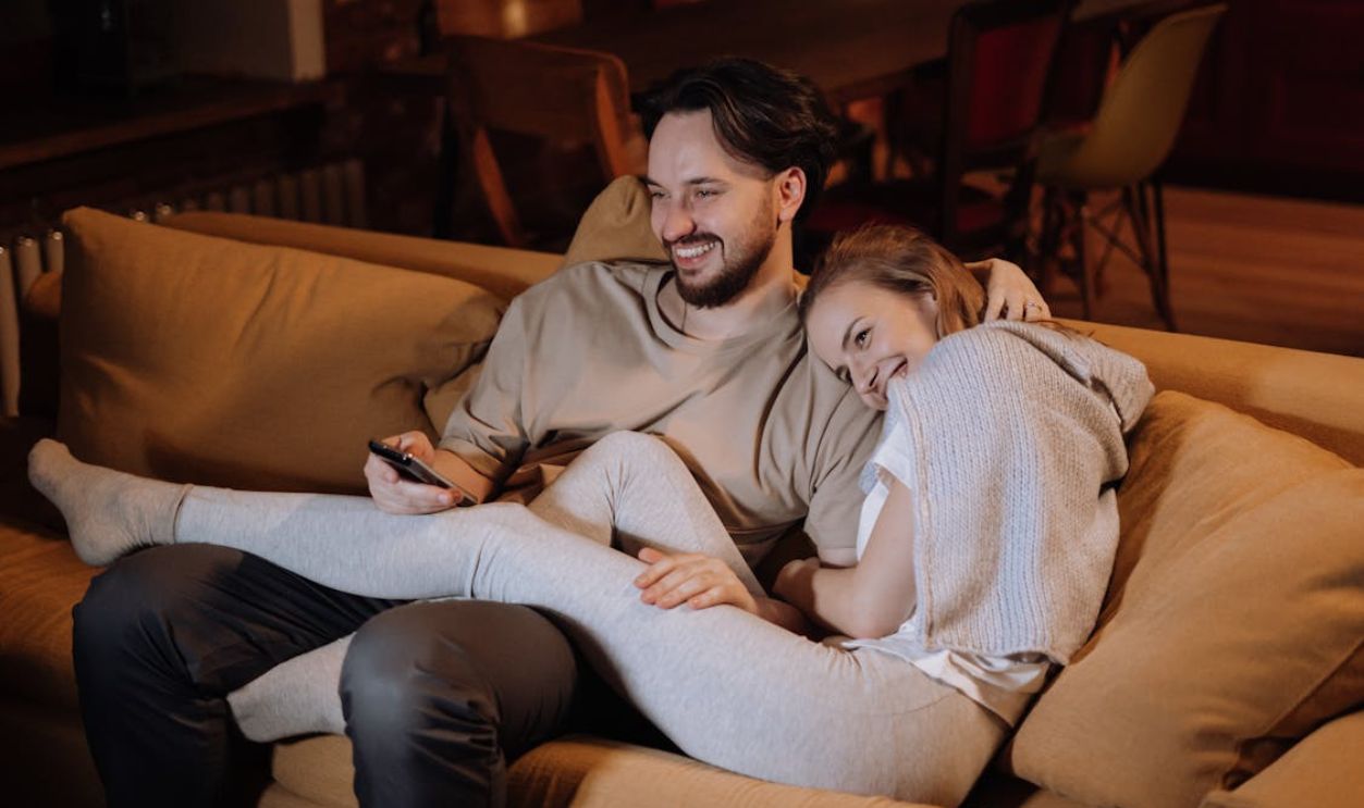 Man and Woman Sitting on Couch