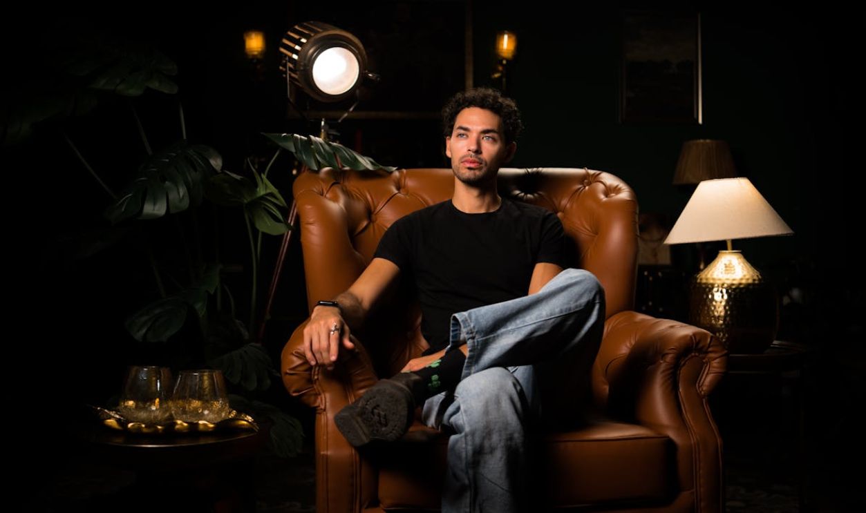 A man sitting in a chair with a lamp on