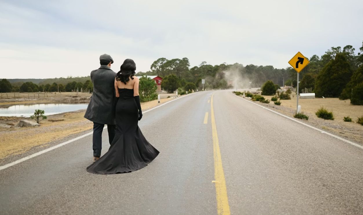 Couple walks down a desolate rural road
