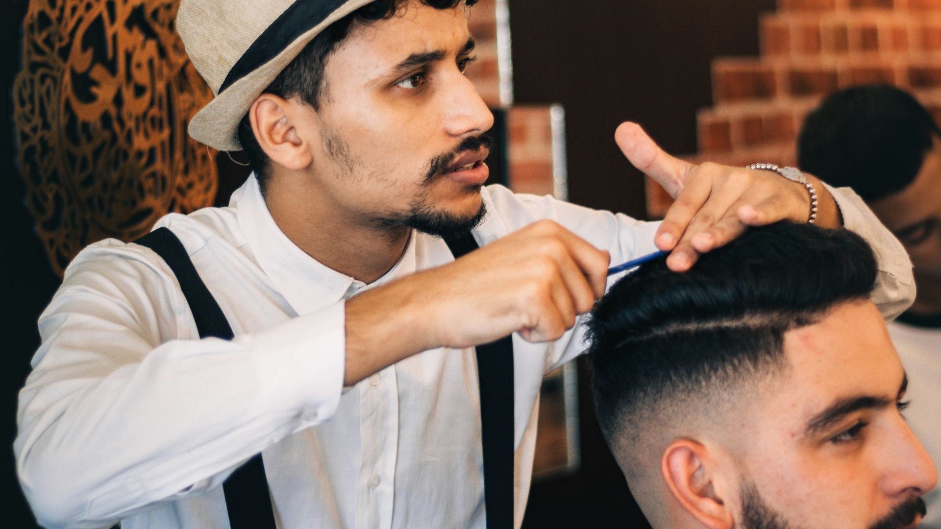 a man getting his hair cut by a barber