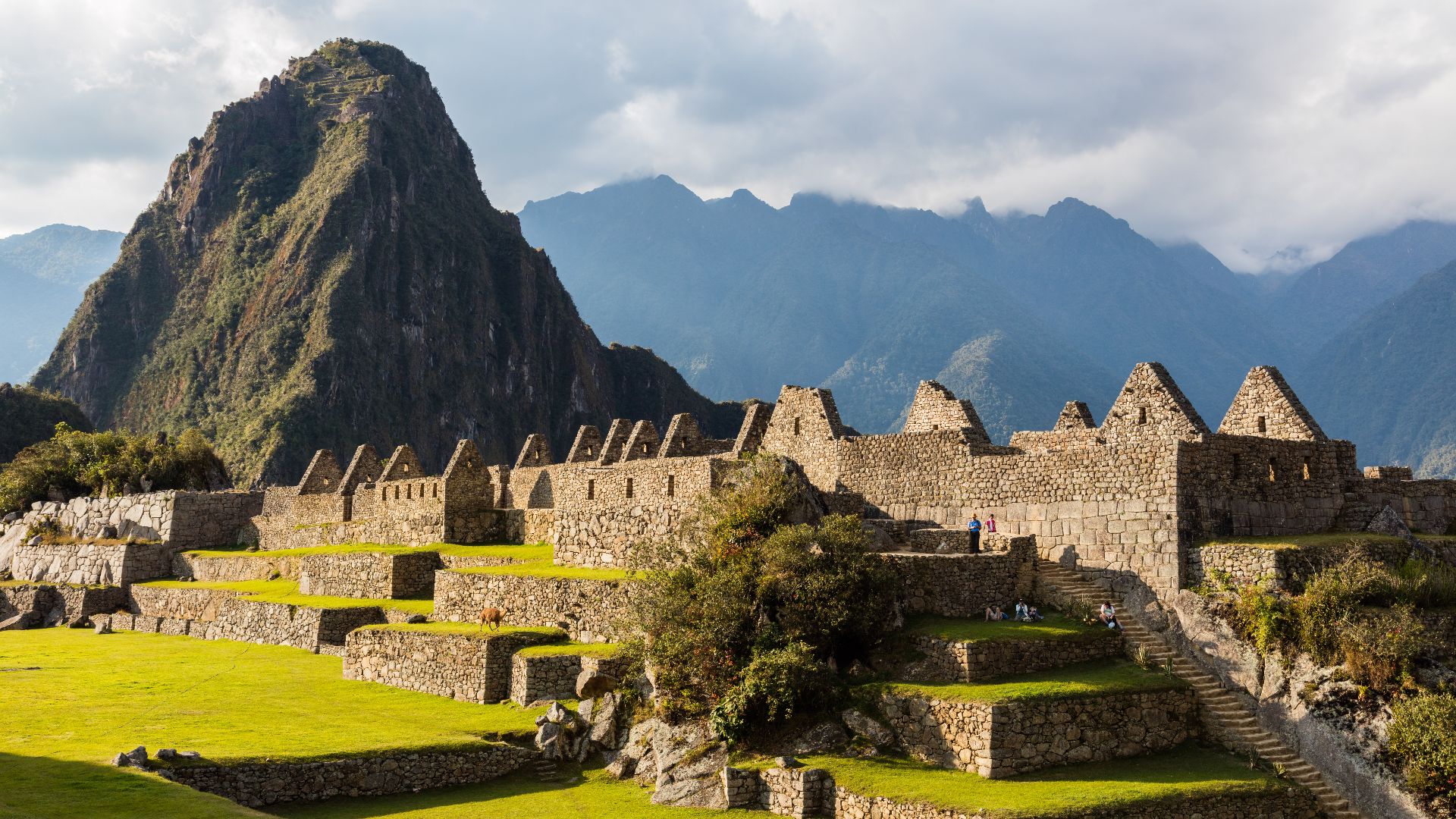 View of the ancient houses of Machu Picchu houses, Urubamba Province, Cusco Region, today Peru. The 15th-century Inca citadel, abandoned one century later, is situated in the Sacred Valley on a mountain ridge 2,430 metres (7,970 ft) above sea level.