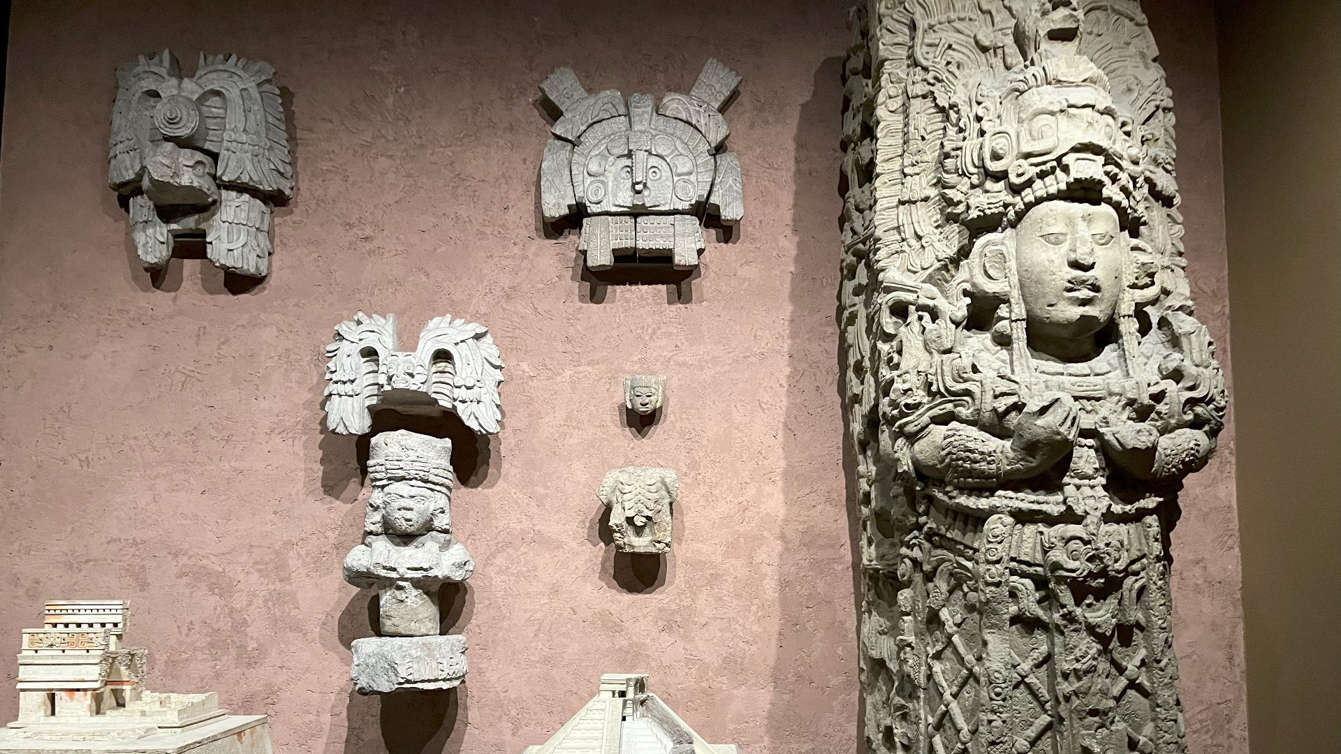 Sculptures on wall are from the Nunnery Quadrangle in Uxmal. Models of buildings at Chichen Itza, Yucatan: Red House and El Castillo. Cast of Stela H. Copan