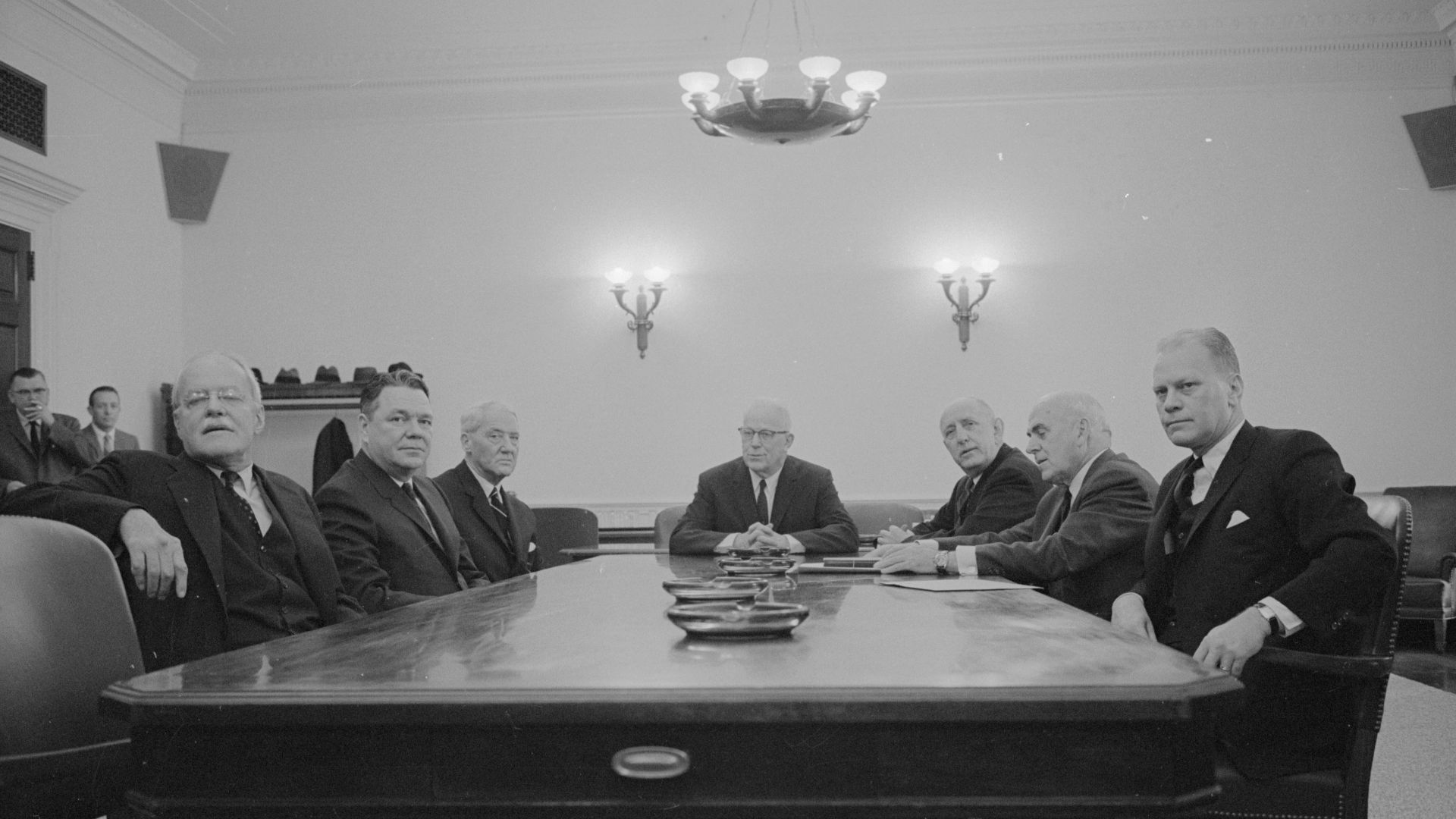 [Members of the Warren Commission gathered around a table including (left-right) former CIA Director Allen W. Dulles, Representative Hale Boggs, Senator John Sherman Cooper, Chairman Chief Justice Earl Warren, Senator Richard B. Russell, John J. McCloy, and Representative Gerald R. Ford] / WKL.