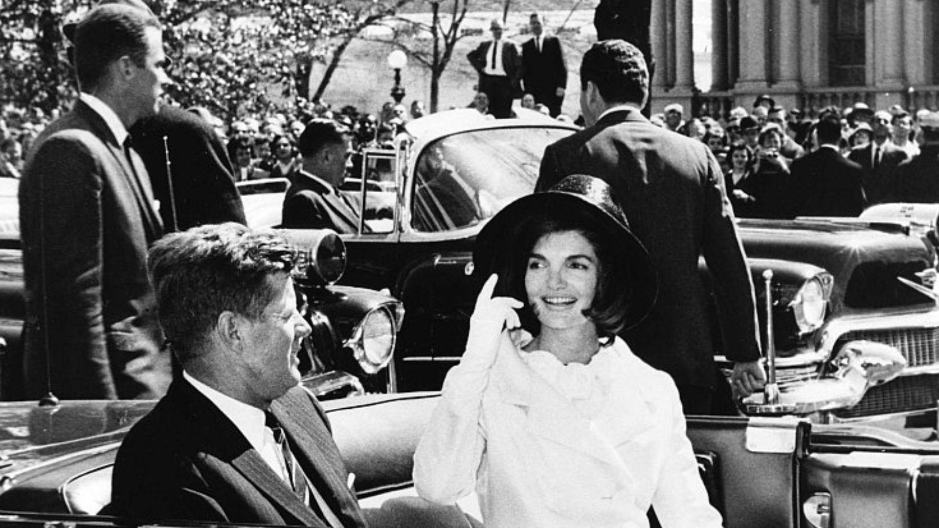 AR 7791-N  27 March 1963  Arrival Ceremonies for King of Morocco. President and Mrs. Kennedy in motorcade. Photograph by Abbie Rowe, National Park Service, in the John F. Kennedy Presidential Library and Museum, Boston.