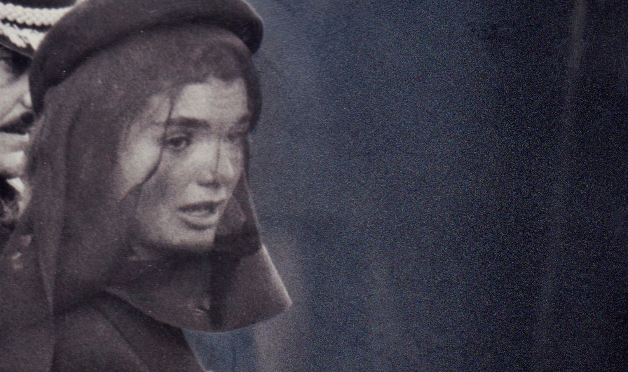 Getty Images - 1071468220 - First Lady Jacqueline Kennedy holds an American flag at the funeral of her husband John F. Kennedy on November 23, 1963.