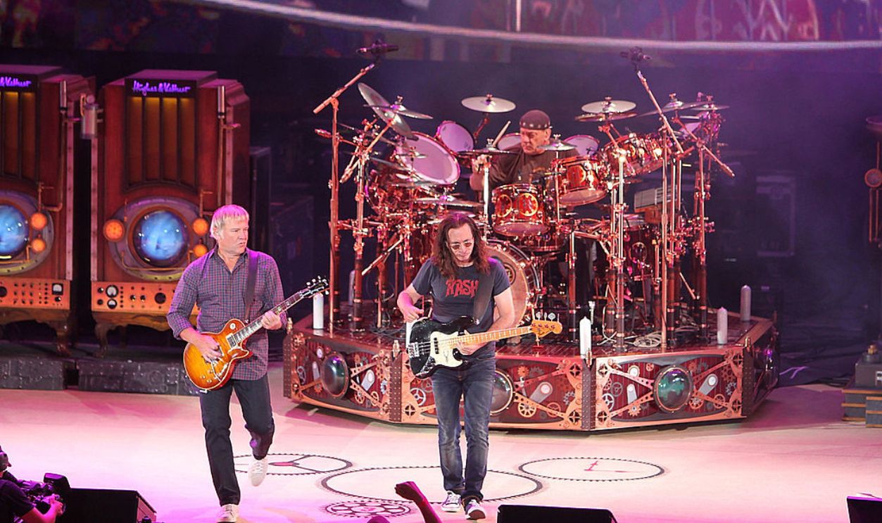 IRVINE, CA - AUGUST 13: (L-R) Guitarist Alex Lifeson, drummer Neil Peart and Bass/singer Geddy Lee of the band Rush perform at Verizon Wireless Amphitheater on August 13, 2010 in Irvine, California. 