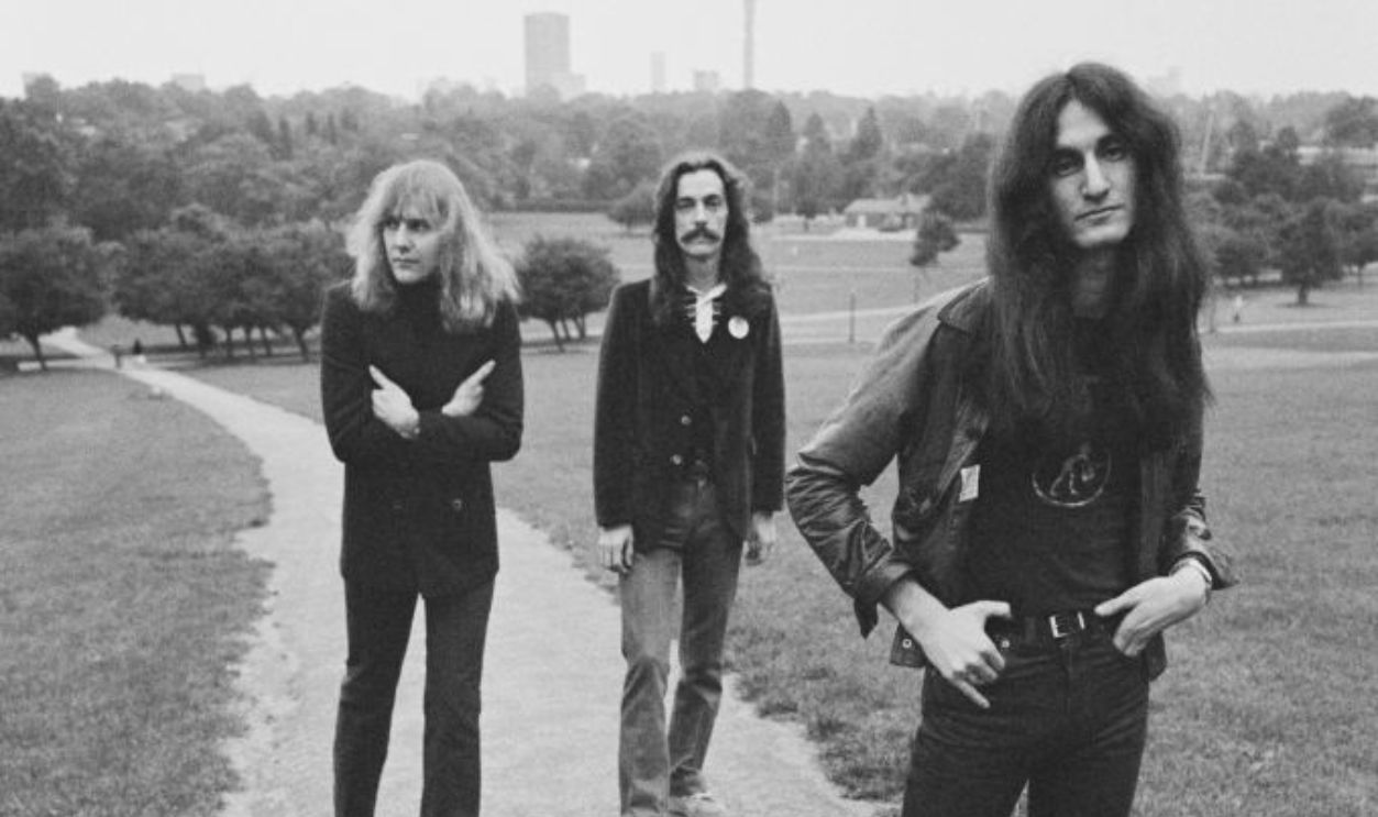Rush (from left: guitarist Alex Lifeson, drummer Neil Peart and bassist and singer Geddy Lee), Canadian rock band, pose for a group portrait on Parliament Hill, on Hampstead Heath, London, England, Great Britain, circa 1978. 