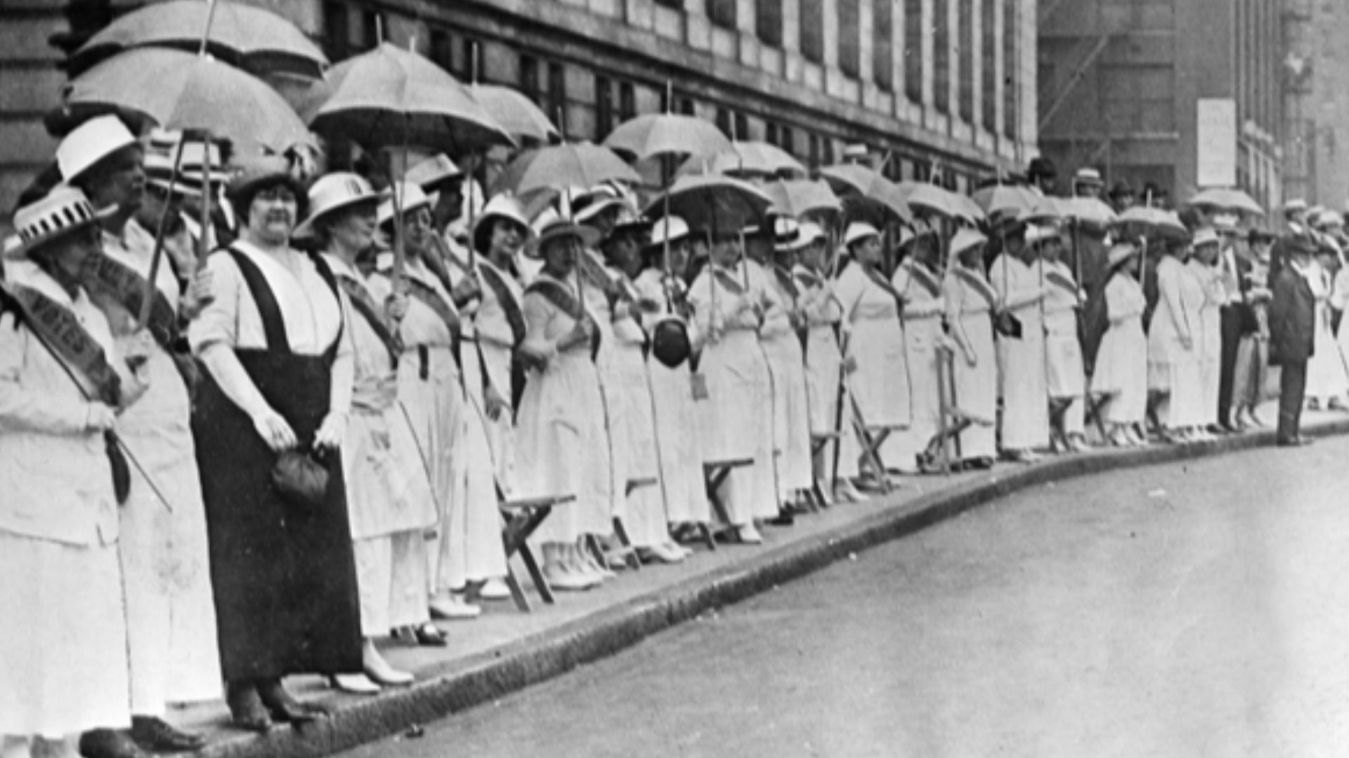 The Golden Lane.
On June 14, 1916, during the Democratic Convention in St. Louis, Missouri, suffragists lined Locust Street with their yellow parasols and sashes displaying the words,