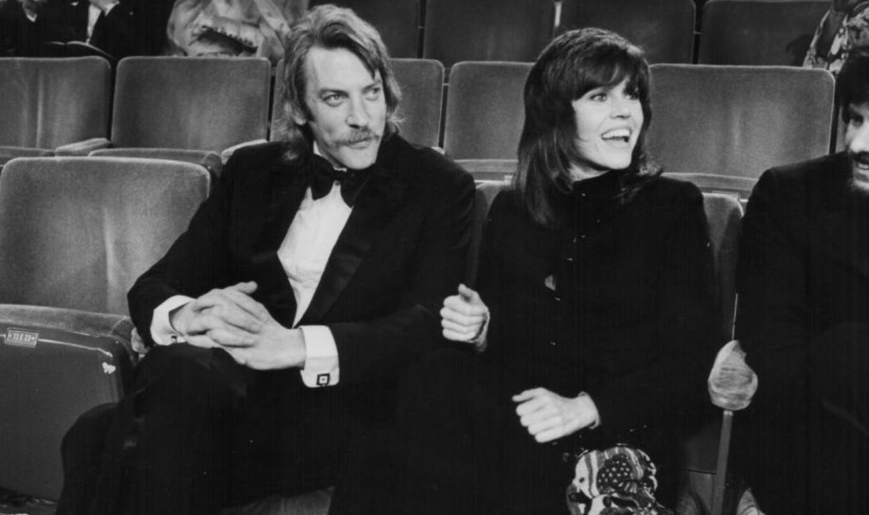 Actors Donald Sutherland and Jane Fonda, in their seats at the Academy Awards, Los Angeles, CA, circa 1970.