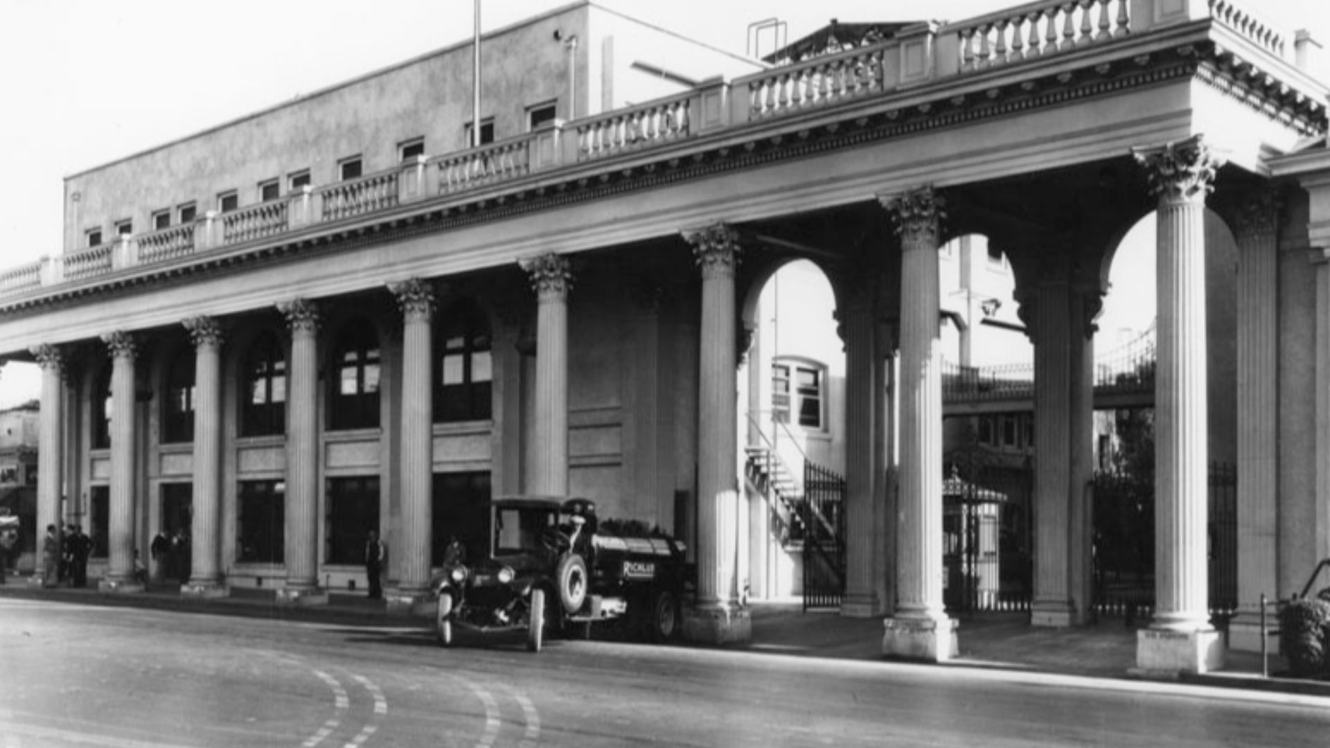 Exterior view of the Triangle at Metro-Goldwyn-Mayer Studios, located at 10202 Washington Boulevard in Culver City. A Richfield gasoline truck is seen in front of the columned building. Photo dated: 1916.
