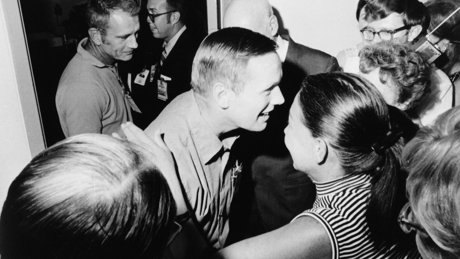 Astronaut Neil A. Armstrong (center), is greeted by friends in the crew reception area of the Lunar Receiving Laboratory. Dr. Gilruth is pictured just to right of Armstrong. Donald K. Slayton, Director of Space Flight Crew Operations, is behind ArmstrongThe Apollo 11 crew left the crew reception area of the Lunar Receiving Laboratory at 9 p.m., Aug. 10, 1969.