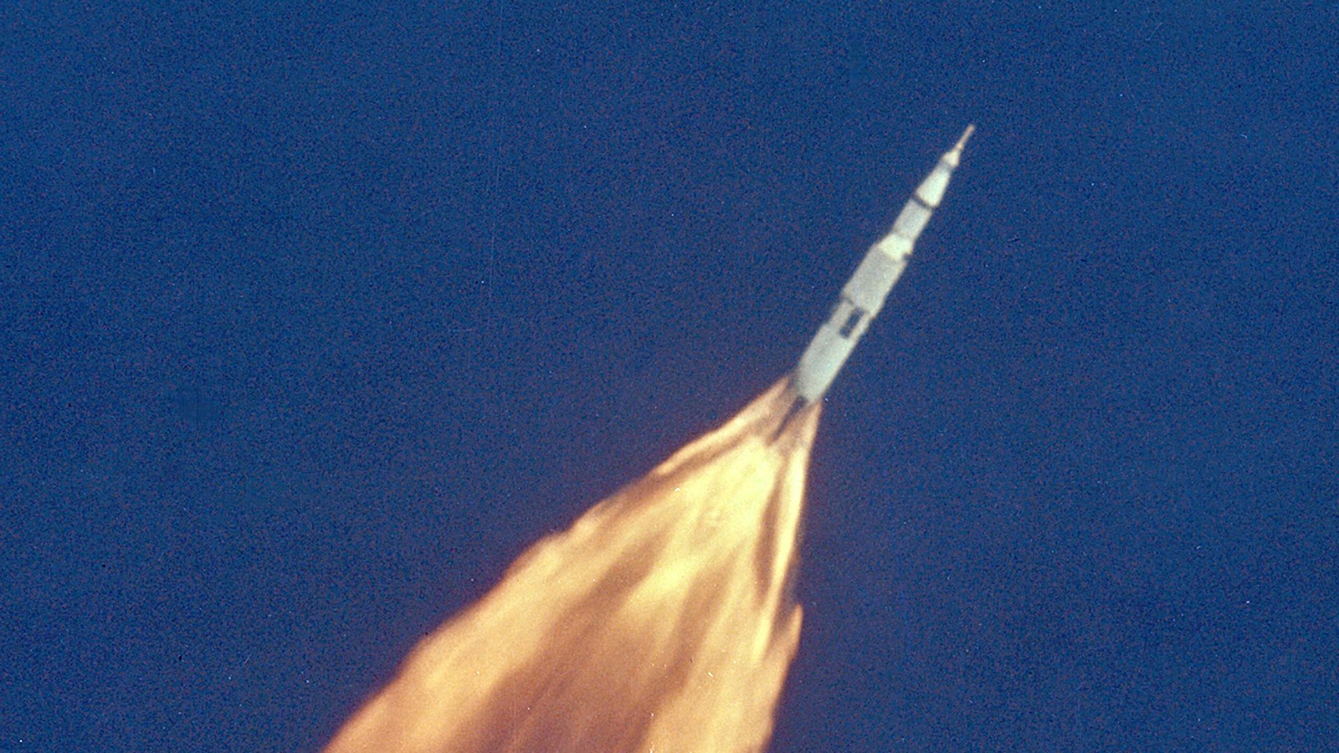 The Apollo 11 Saturn V space vehicle climbs toward orbit after liftoff from Pad 39A at 9:32 a.m. EDT. In 2 1/2 minutes of powered flight, the S-IC booster lifts the vehicle to an altitude of about 39 miles some 55 miles downrange. This photo was taken with a 70mm telescopic camera mounted in an Air Force EC-135N plane. Onboard are astronauts Neil A. Armstrong, Michael Collins and Edwin E. Aldrin, Jr.
