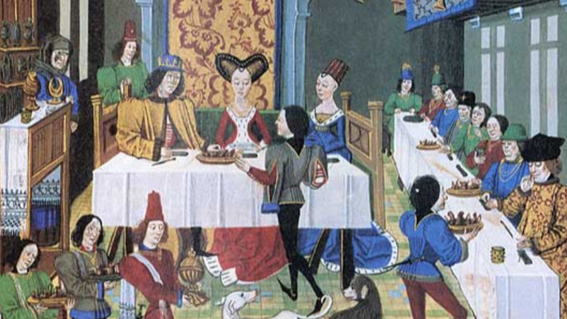 Enluminure extraite d’Histoire d'Olivier de Castille et d'Artus d'Algarbe, folio 181v. La table d'honneur est isolée sous un dais, tandis que le gros des convives se répartit le long d'une table, dont ils n'occupent qu'un côté. Le ballet des serviteurs est mené par le maître d'hôtel, tandis qu'au buffet et près du prince veillent d'autres officiers de bouche, prêts à répondre à ses moindres désirs. Des musiciens égayent le repas.