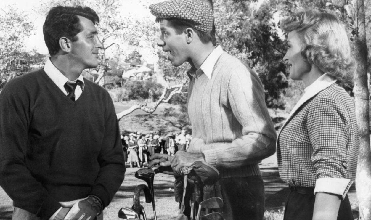 Dean Martin at a golf course with Jerry Lewis and Donna Reed in a scene from the film 'The Caddy', 1953. 