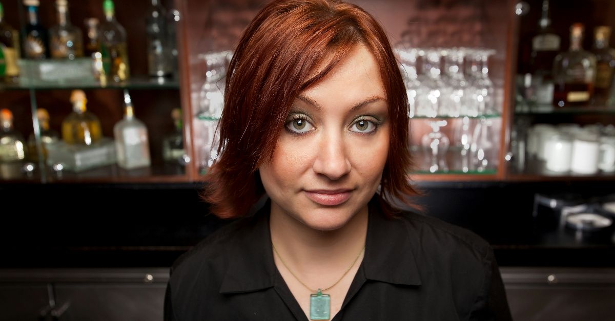 woman in black blazer smiling