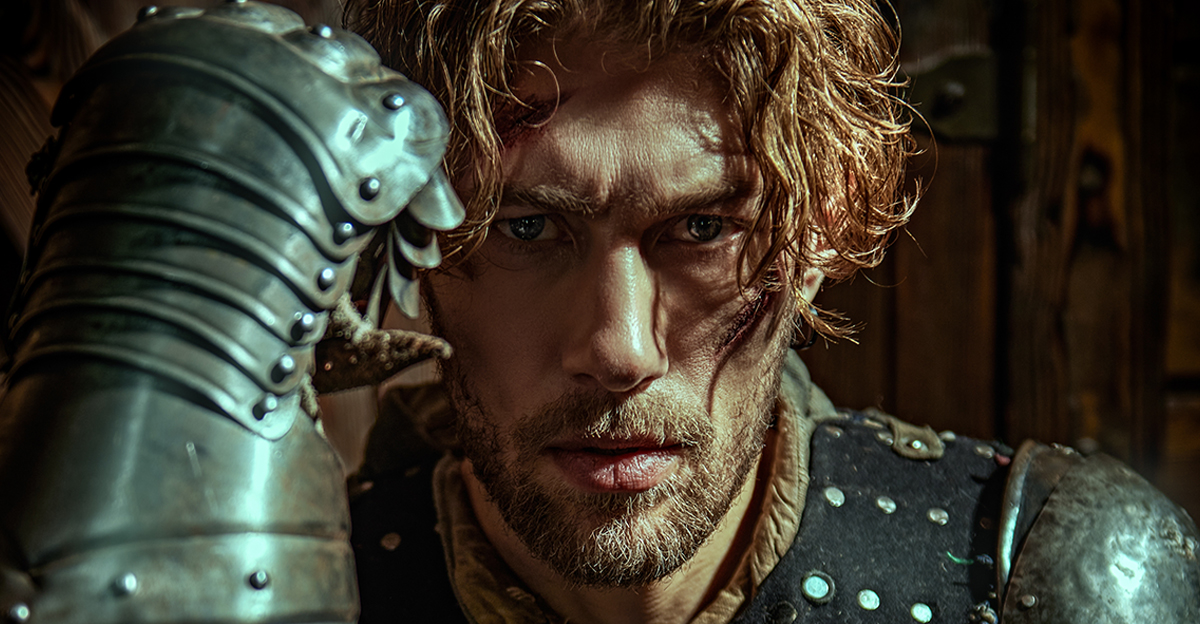 A handsome noble medieval knight in armor standing in a castle. Historical reconstruction. 