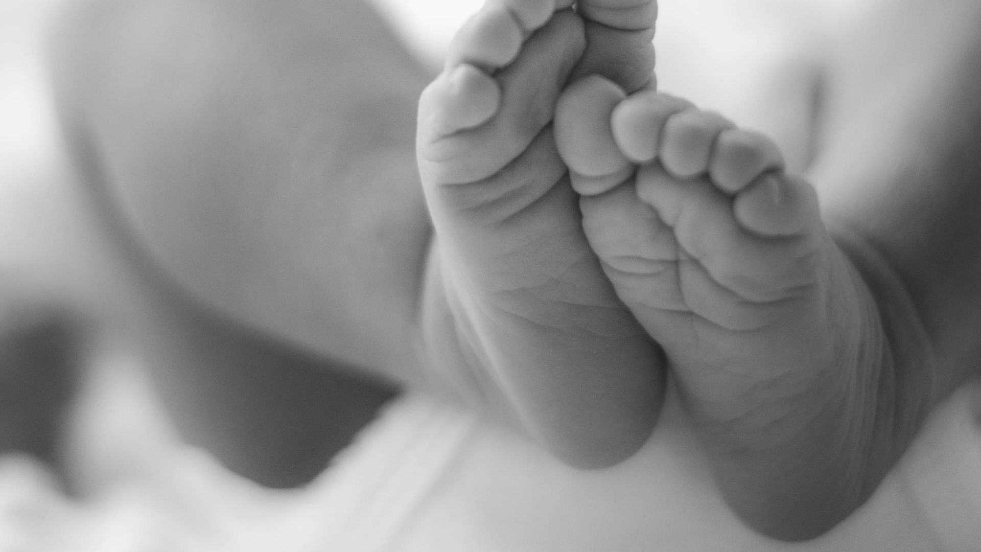 grayscale photo of babys feet