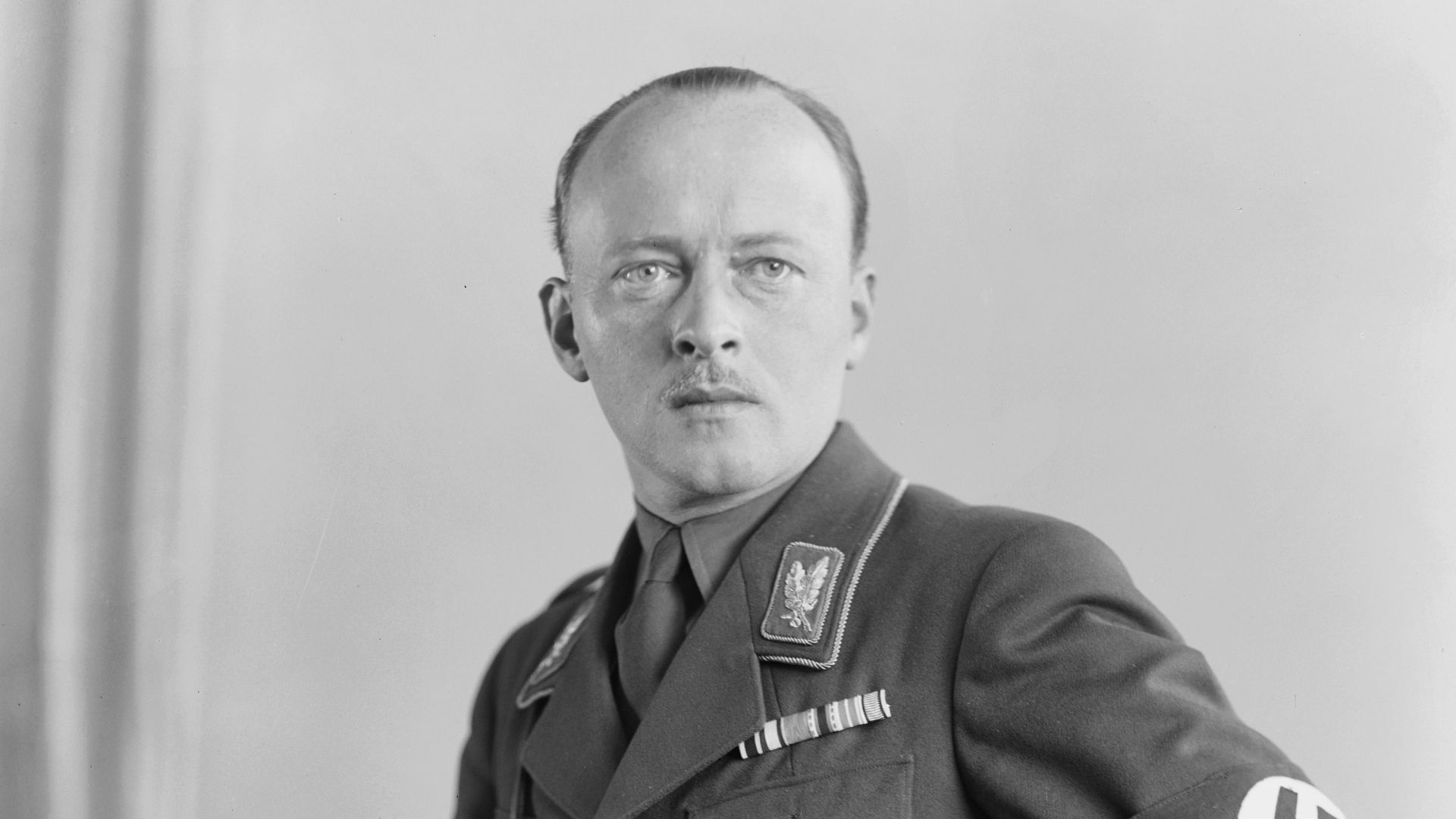 Portrait photo of Philipp, Prince and Landgrave of Hesse (1896 – 1980) wearing his brown Sturmabteilung uniform with swastika armband (brassard), belt with shoulder strap, SA-Oberfuehrer collar patches, medal ribbon bars, Iron Cross (1914), riding breeches, etc. 
Photo copied from a collection of the US National Archives and Records Administration (NARA): Record Group 242: National Archives Collection of Foreign Records Seized, 1675 - 1958 Series: Miscellaneous Photographs, ca. 1919 - ca. 1934. Unrestricted access and use; photograph held by the National Archives in the public domain as seized enemy property after World War II.