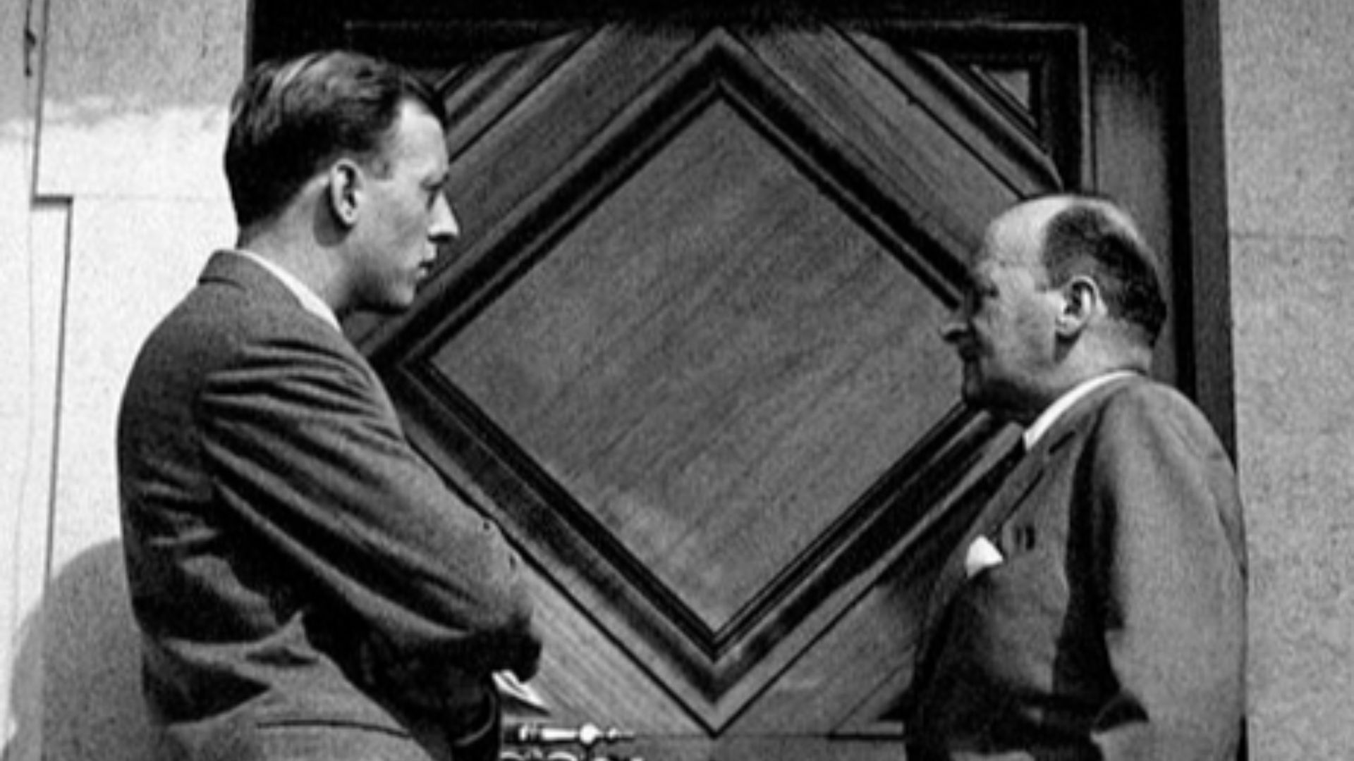 Philipp of Hesse, Landgrave of Hesse-Kassel, and his son Mortiz of Hesse in front of a closed door at the wedding of Princess Maria Pia of Savoy, daughter of King Umberto II of Italy, and Prince Alexander of Yugoslav. Cascais, February 1955