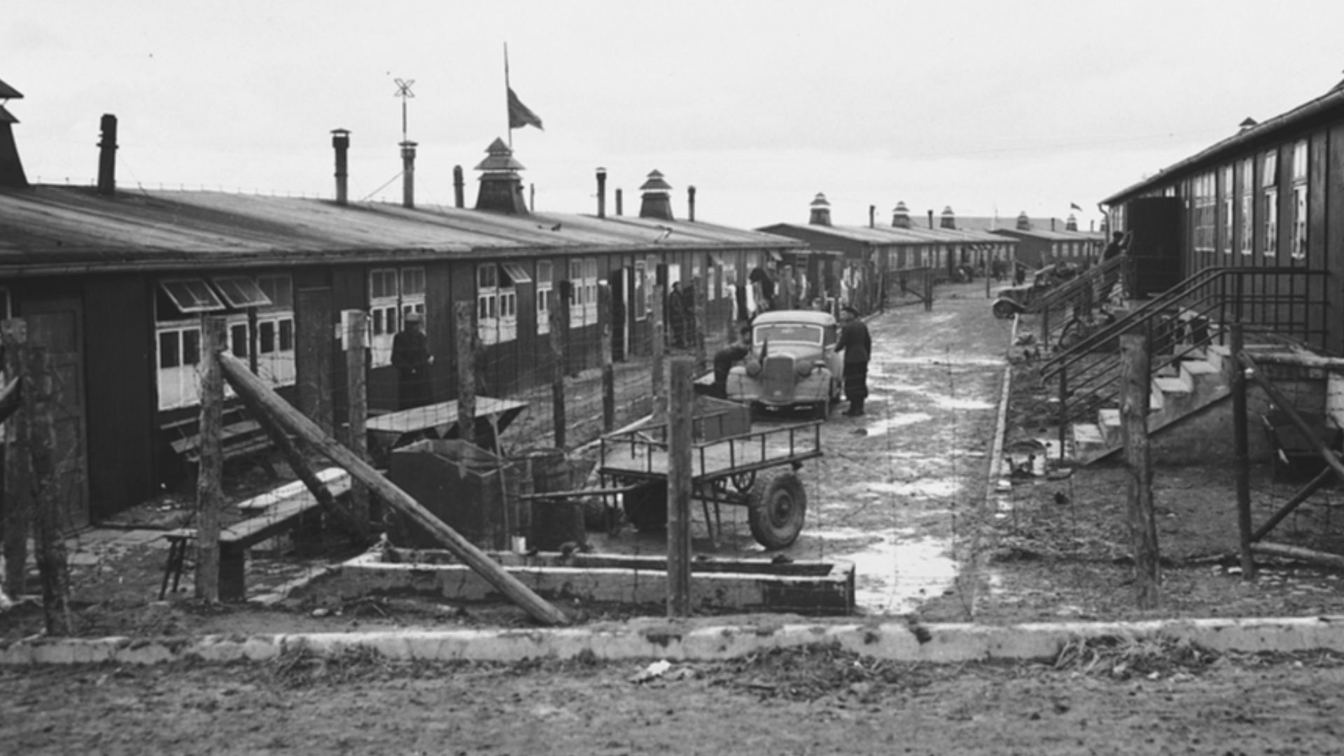 View of a street in the Buchenwald concentration camp lined with barracks on either side.