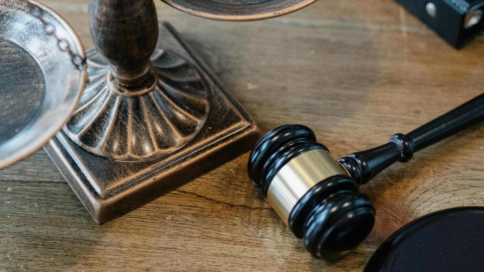 From above of judicial symbols consisting of Scales of Justice and small judge hammer with curly handle