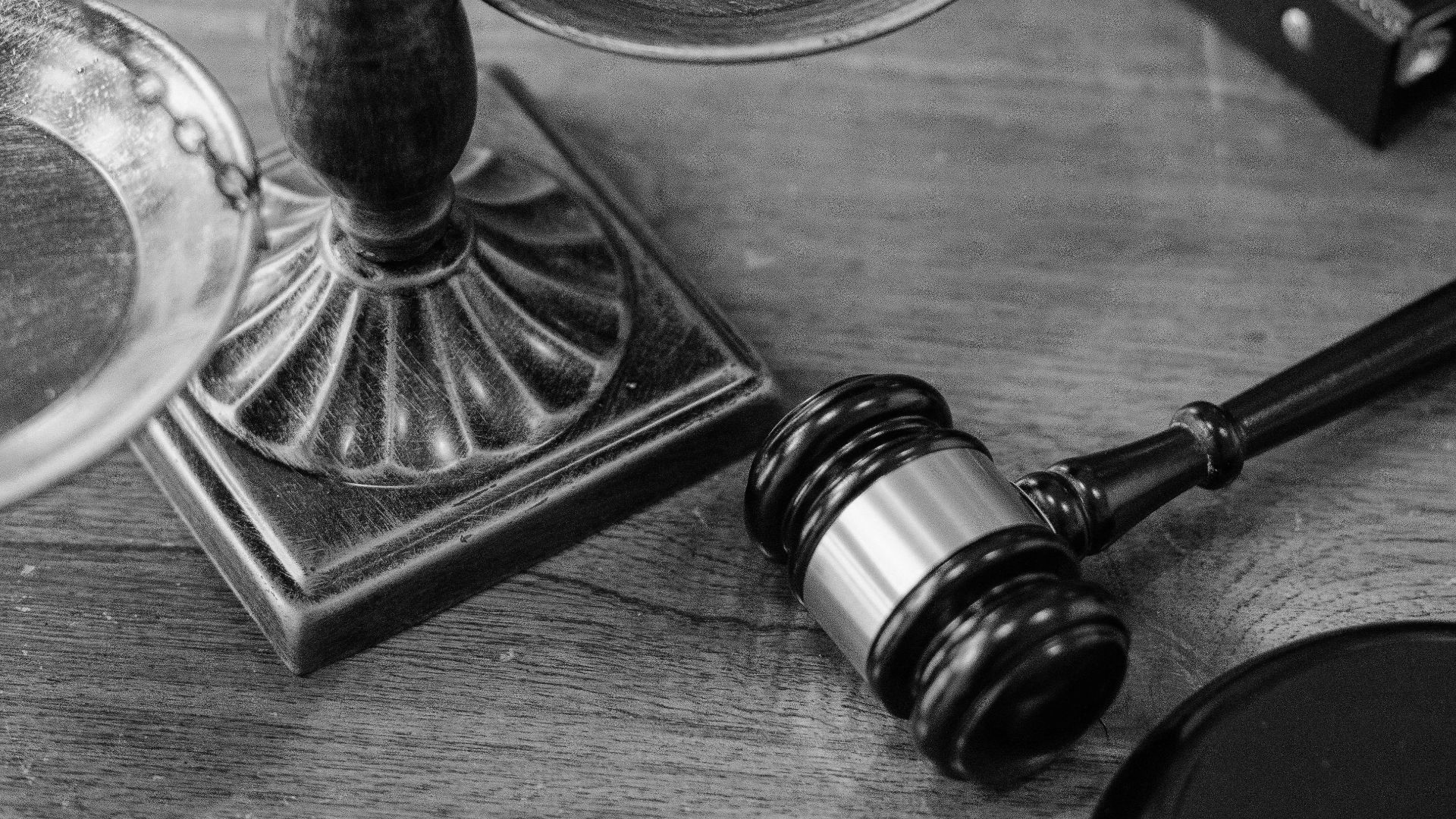 From above of judicial symbols consisting of Scales of Justice and small judge hammer with curly handle