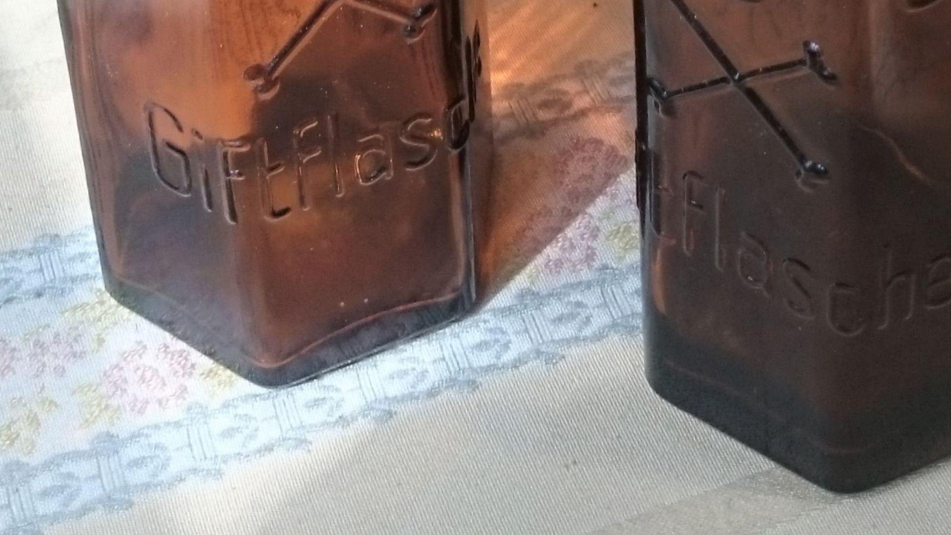 Amber glass apothecary bottles, hexagonal base. Inscriptions read