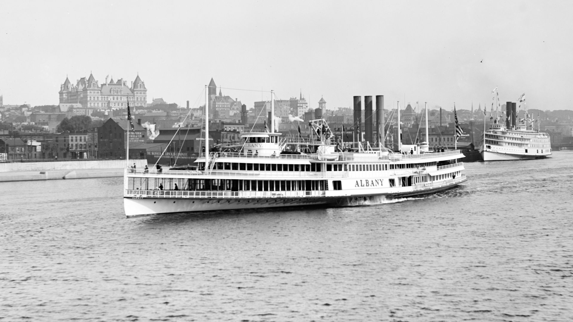 The Steamer Albany, of Hudson River Day Line, on the Hudson River at Albany, New York, United States. In the background can be seen the New York State Capitol and Albany City Hall.