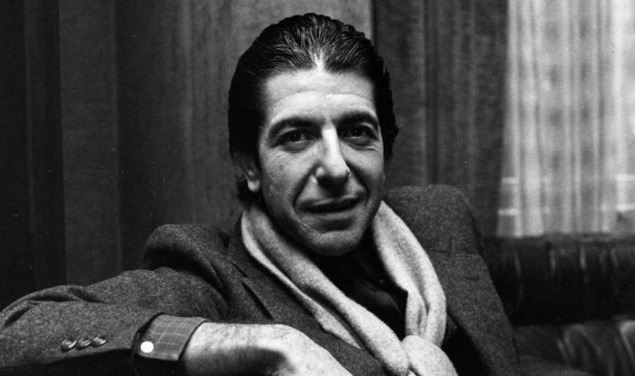 8th January 1980: Solemn Canadian folk pop singer-songwriter Leonard Cohen shares a joke and smokes a cigarette. 