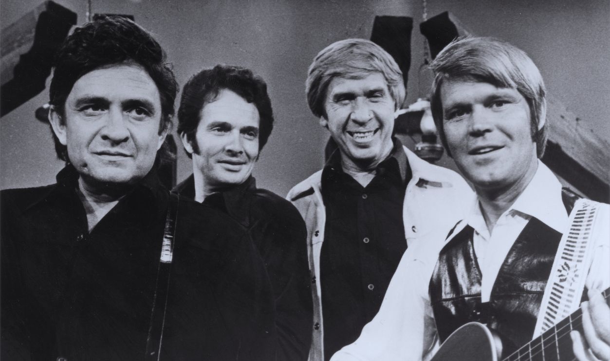 Gettyimages - 74256357, Glen, Merle, Buck And Johnny Singer and songwriters (L-R) Johnny Cash, Merle Haggard, Buck Owens and Glen Campbell perform on the Glen Campbell Goodtime Hour in 1972 in Los Angeles, California. 
