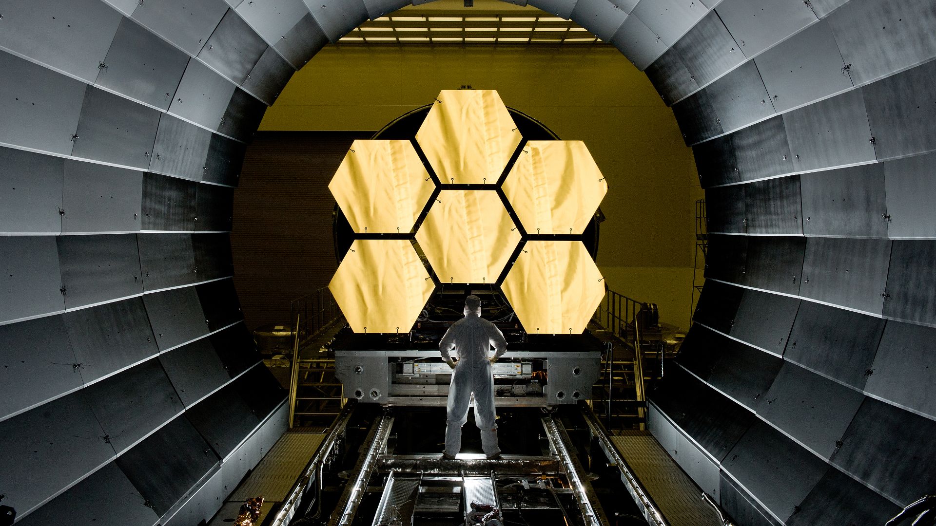 NASA engineer Ernie Wright looks on as the first six flight ready James Webb Space Telescope's primary mirror segments are prepped to begin final cryogenic testing at NASA's Marshall Space Flight Center.