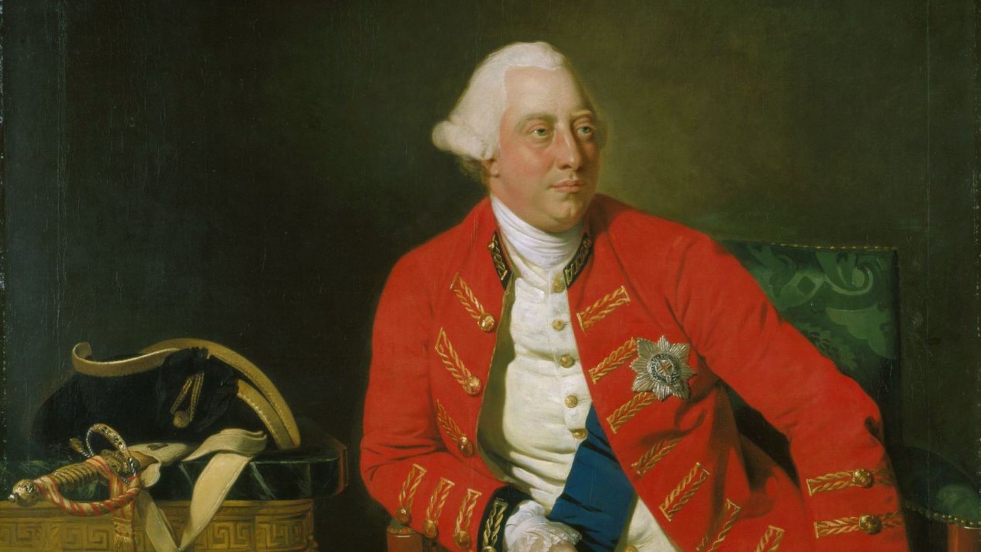 A three quarter length figure of King George III seated in a General Officer's coat with the ribbons and star of the Garter, wearing the Garter around his leg; his hat and sword resting on a nearby table. Finished in 1771 it portrays the king at age 33, with a steady serious gaze, a ruddy healthy face, and a calm assured demeanor.