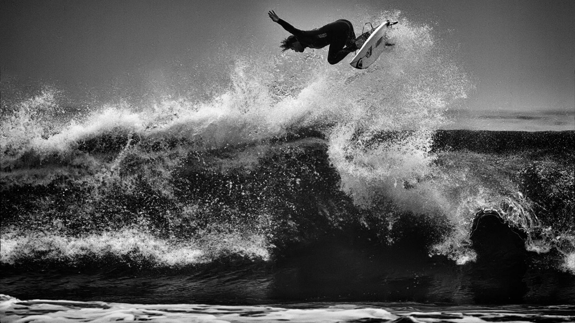 Another flying surfer from the US Open in Huntington Beach.
ISO 200, 365mm, f5.6, 1/1250.

Processed in Adobe Camera Raw to increase exposure and blacks. Imagenomic Noiseware noise reduction, and black and white conversion using Nik Silver Efex.