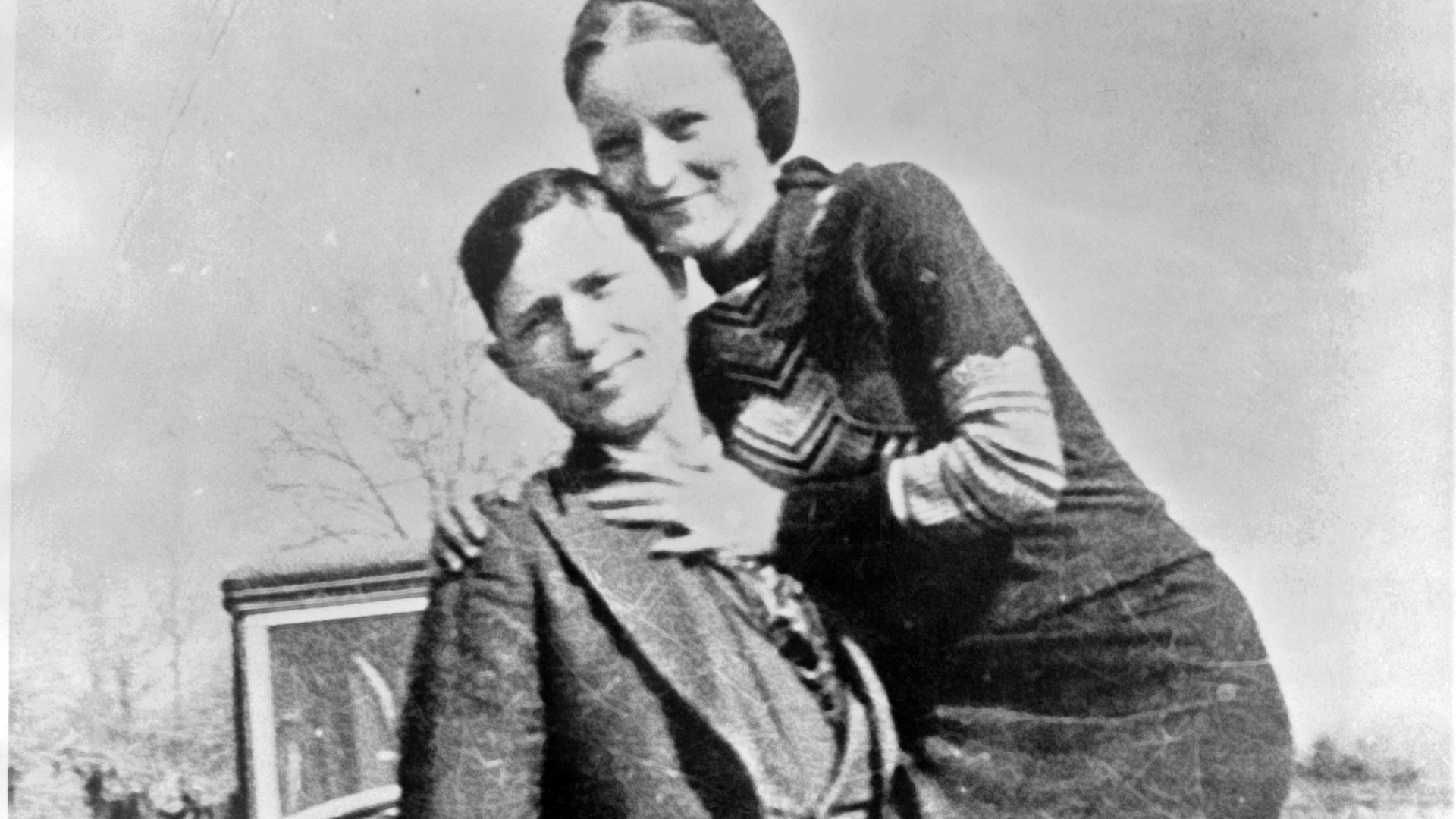 Bonnie Parker and Clyde Barrow, sometime between 1932 and 1934, when their exploits in Arkansas included murder, robbery, and kidnapping. Contrary to popular belief the two never married. They were in a longstanding relationship. Posing in front of a 1932 Ford V8 automobile. Recovered from Bonnie and Clyde after their deaths on May 23, 1934.