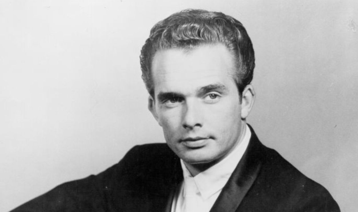 Country musician Merle Haggard poses for a Tally Records portrait with a guitar in 1963.