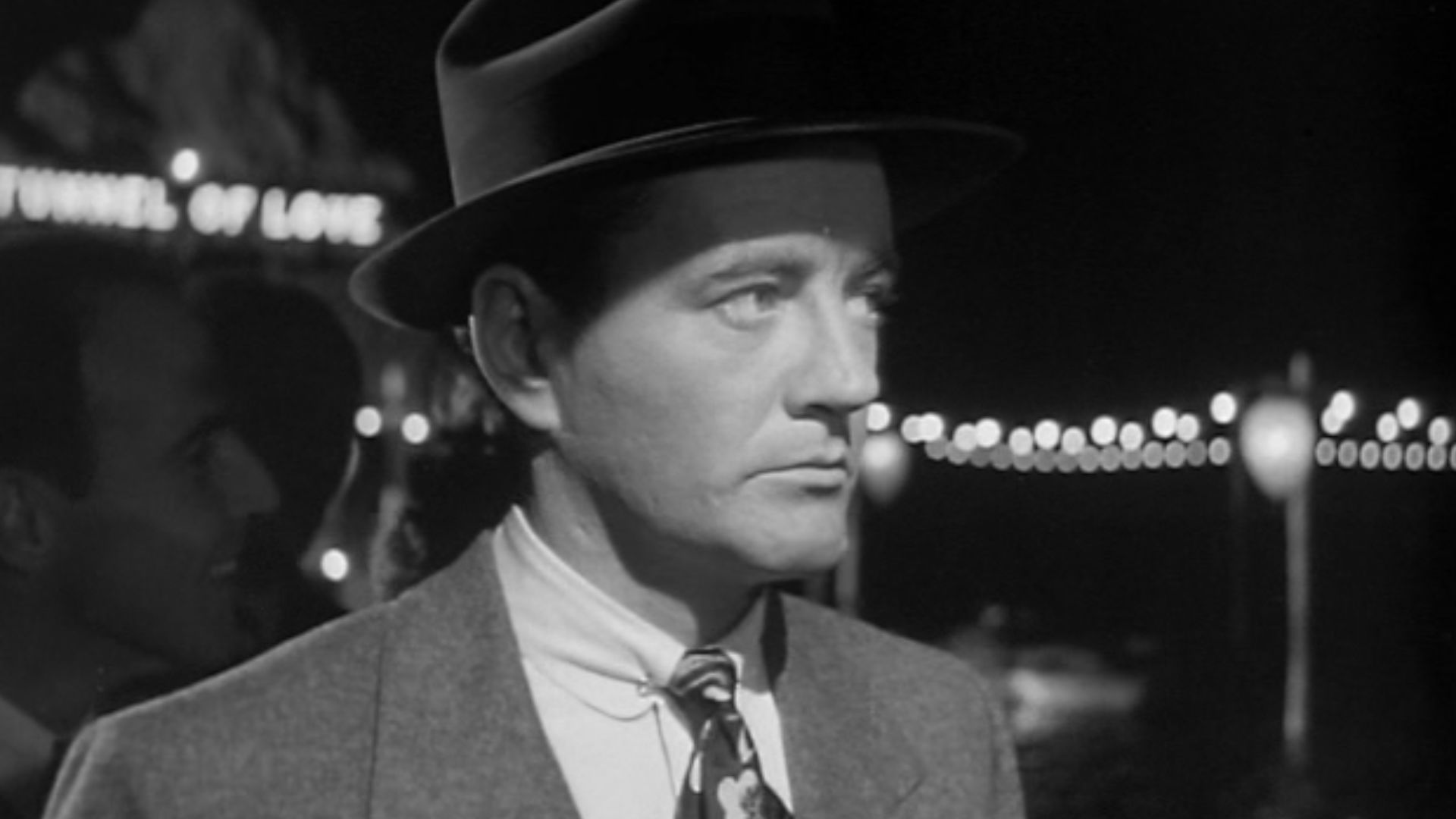 Bruno Anthony (Robert Walker) in line for the Tunnel of Love in Alfred Hitchcock's 1951 Strangers on a Train (trailer)