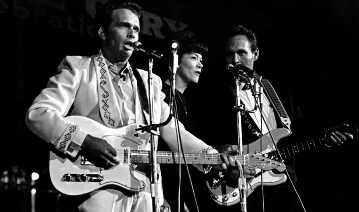 NASHVILLE, TN - 1967: Country musician Merle Haggard performs on stage with singer Bonnie Owens and the bass player from his band 
