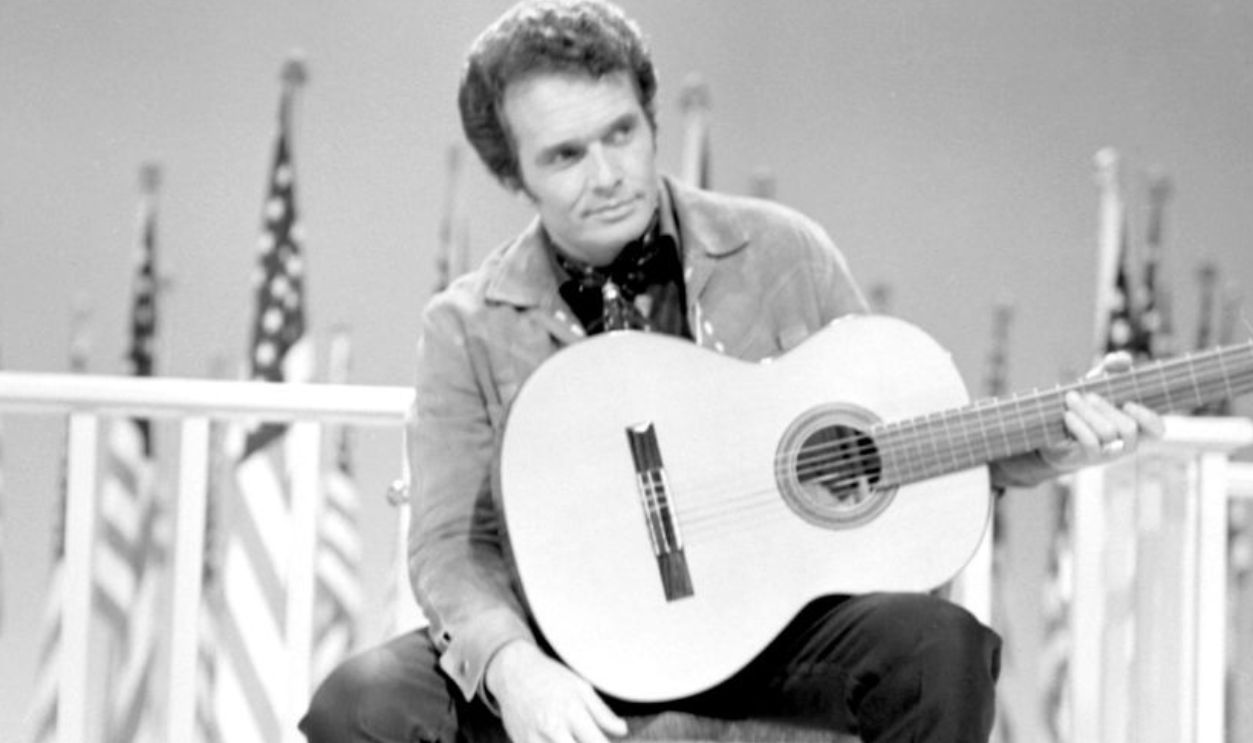 LOS ANGELES - 1967: Country musician Merle Haggard performs on stage with a dog during a 1967 television show in Los Angeles, California.