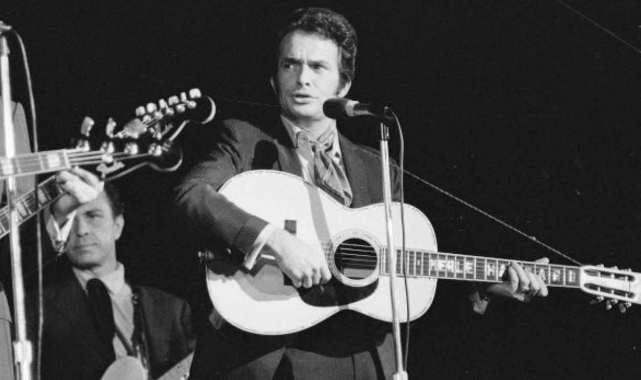 American country music performer Merle Haggard (right) performs on stage with his band, 1970.