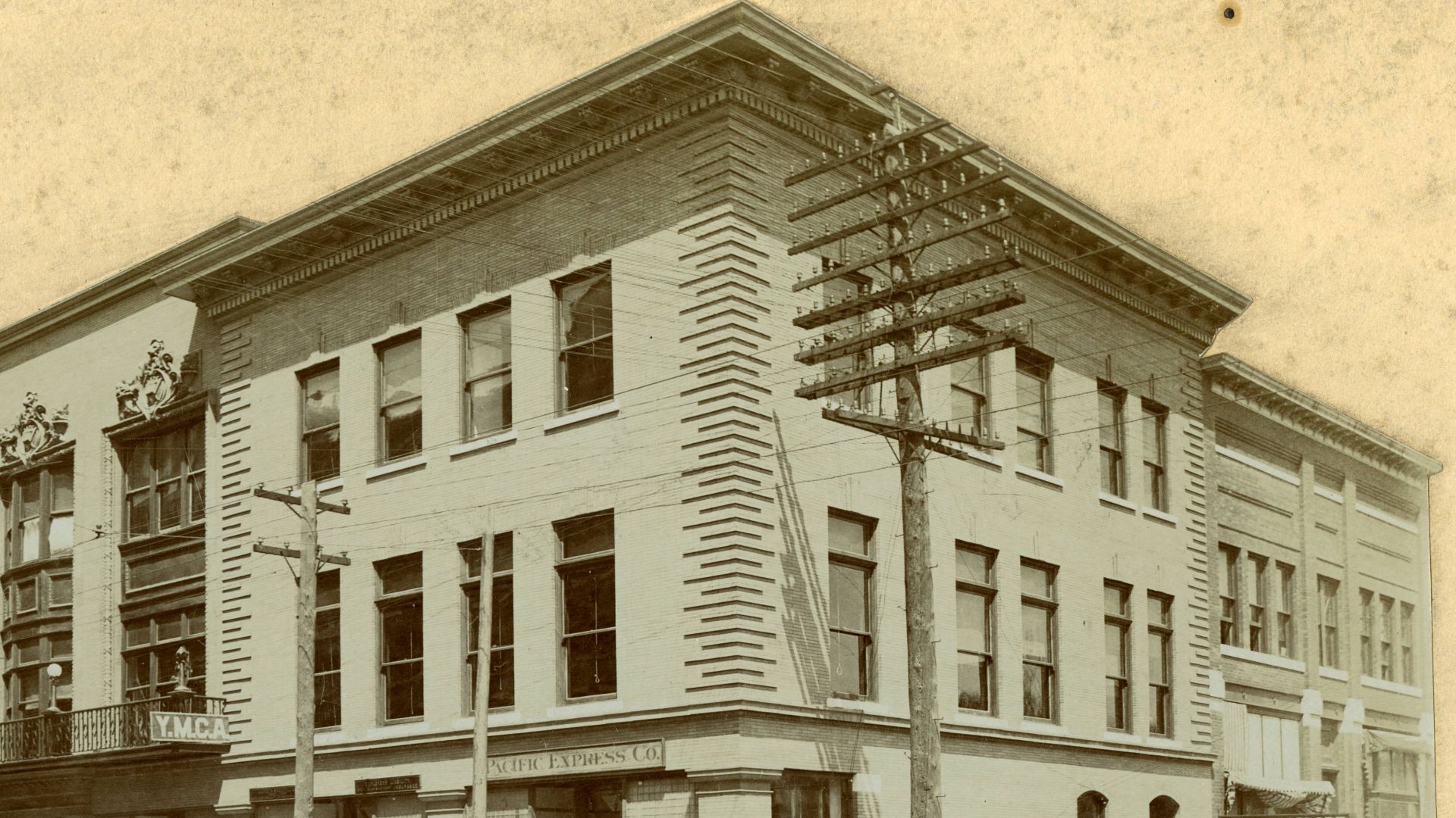 View of exterior of Fourth Street, between Main and Virginia, showing Pacific Express Company, Y.M.C.A. and Joplin Daily Globe.