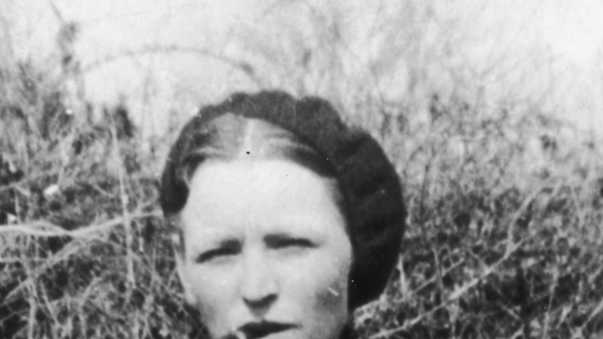 A snapshot of criminal Bonnie Parker smoking a cigar, seized by police 4-13-1933.