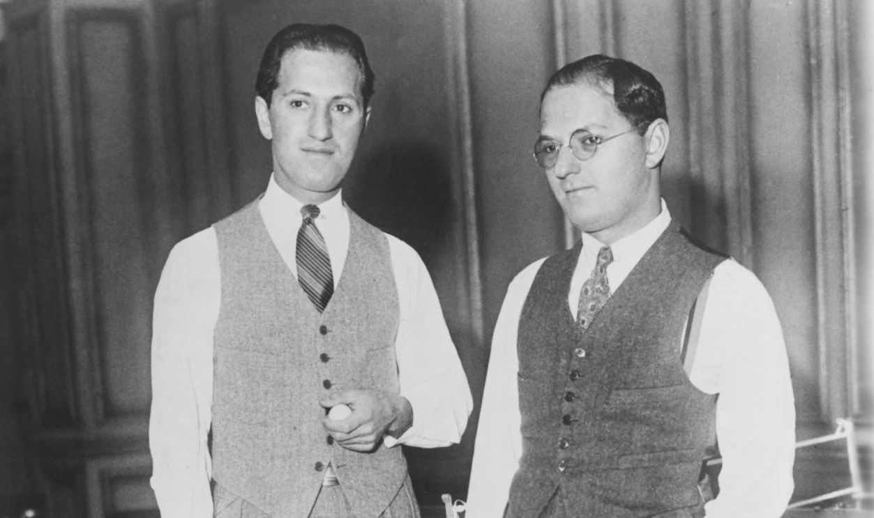 Brothers George (left) and Ira Gershwin take a break from playing table tennis, circa 1925.