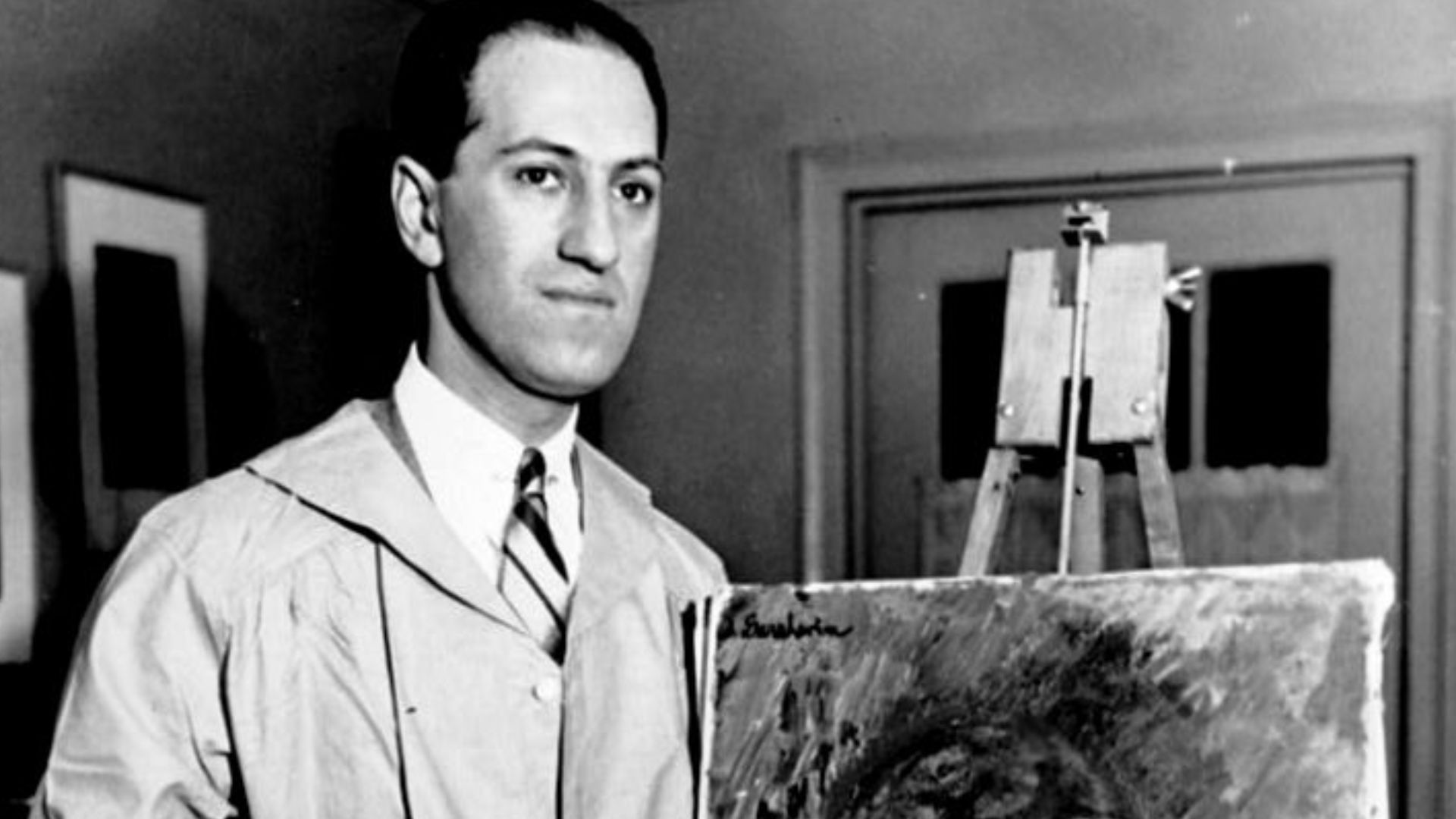 George Gershwin in his New York apartment with his first oil painting.