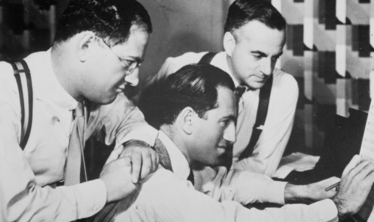 Composer George Gershwin (C) with his brother lyricist Ira Gershwin and dramatist Guy Bolton work on the score for the film 