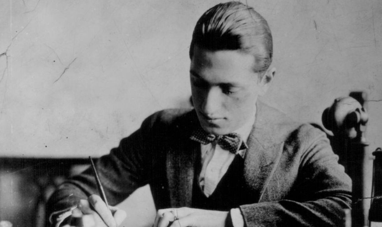 Portrait of music composer George Gershwin in his youth, working at his desk for Max Dreyfuss, the head of Chappell Music Camp in New York, circa 1915-1925. 