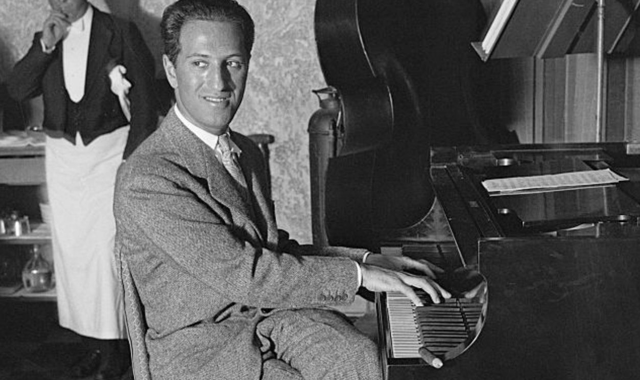 (Original Caption) 2/19/1930-Miami Beach, FL- George Gershwin, foremost, present-day, music composer, is seen here at the piano, at the Deauville pool where he is vacationing.